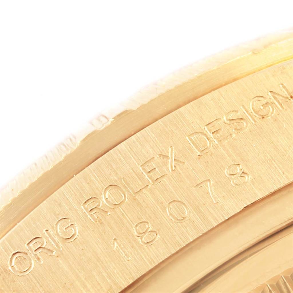 The image shows a close-up of the engraved side of a Rolex President 18078 Men
s Yellow Gold Champagne Dial 18078 Men
s Yellow Gold Champagne Dial model watch.
