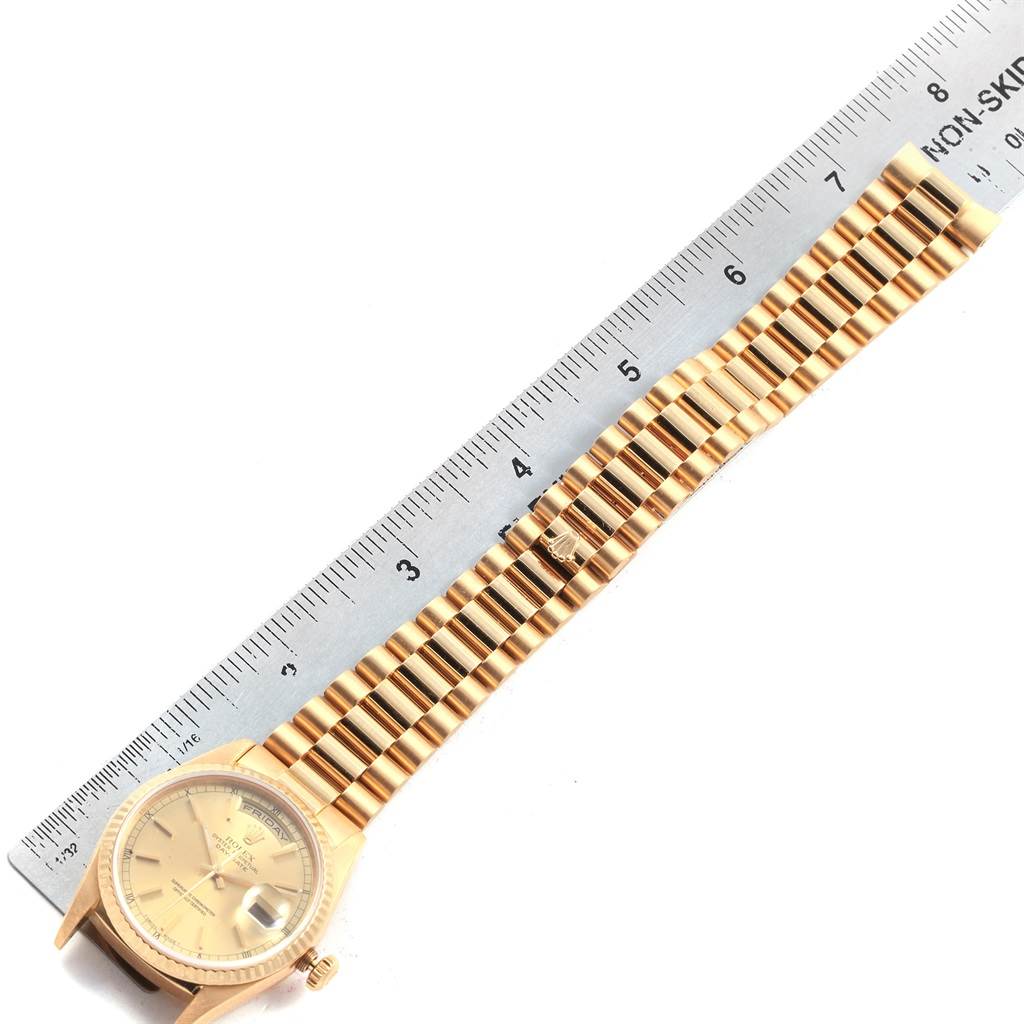 This image shows a Rolex President 18238 Men
s Yellow Gold Champagne Dial 18238 Men
s Yellow Gold Champagne Dial model watch laid flat, with a ruler next to it for size reference.