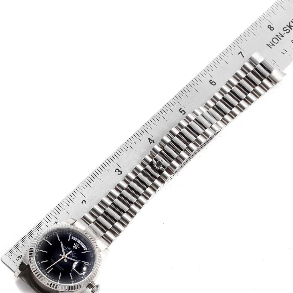 The image shows a Rolex President 118239 Men's White Gold Black Dial 118239 Men's White Gold Black Dial model watch at an oblique angle, featuring its face and bracelet, with a ruler for scale.