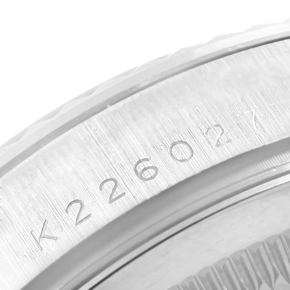 This image shows a close-up of the side of a Rolex President 118239 Men's White Gold Black Dial 118239 Men's White Gold Black Dial model watch, highlighting its engraved serial number.