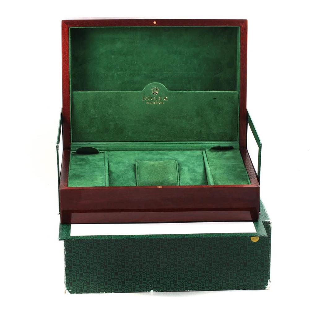 This image shows an open green and wooden Rolex watch box for the President model.
