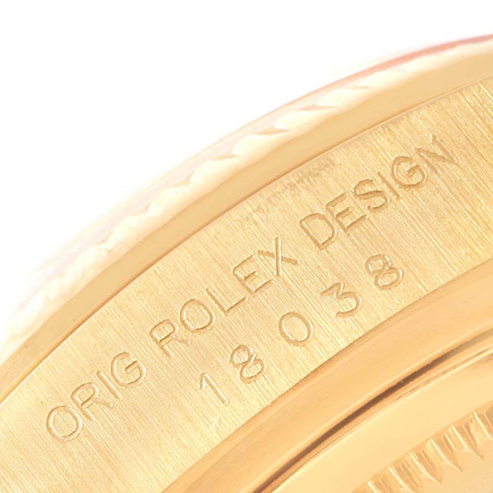 This close-up image shows the engraved bezel of a Rolex President 18038 Men
s Yellow Gold Silver Dial 18038 Men
s Yellow Gold Silver Dial model watch.