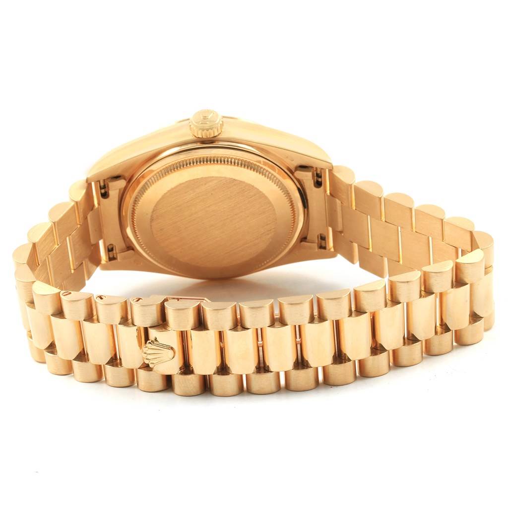 The image shows the backside and bracelet of a Rolex President 18038 Men
s Yellow Gold Silver Dial 18038 Men
s Yellow Gold Silver Dial model watch in gold.