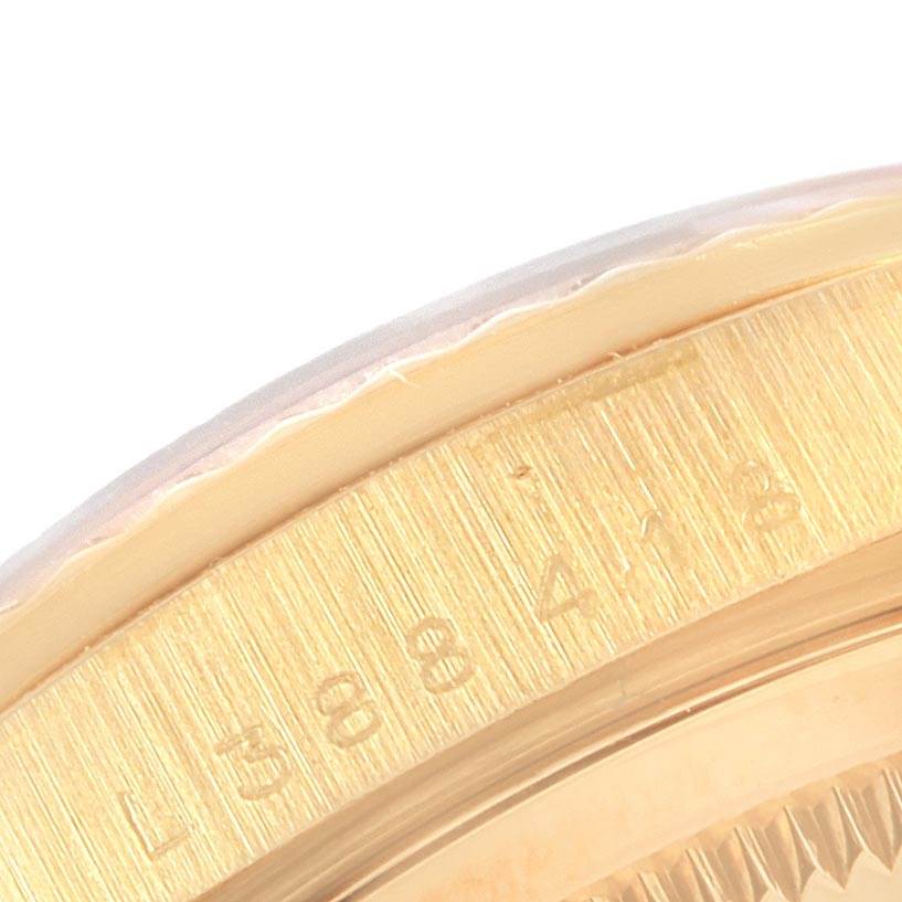 The image shows a close-up of the gold bezel and serial number engraving on the Rolex President 16238 Men
s Yellow Gold Champagne Dial 16238 Men
s Yellow Gold Champagne Dial watch model.