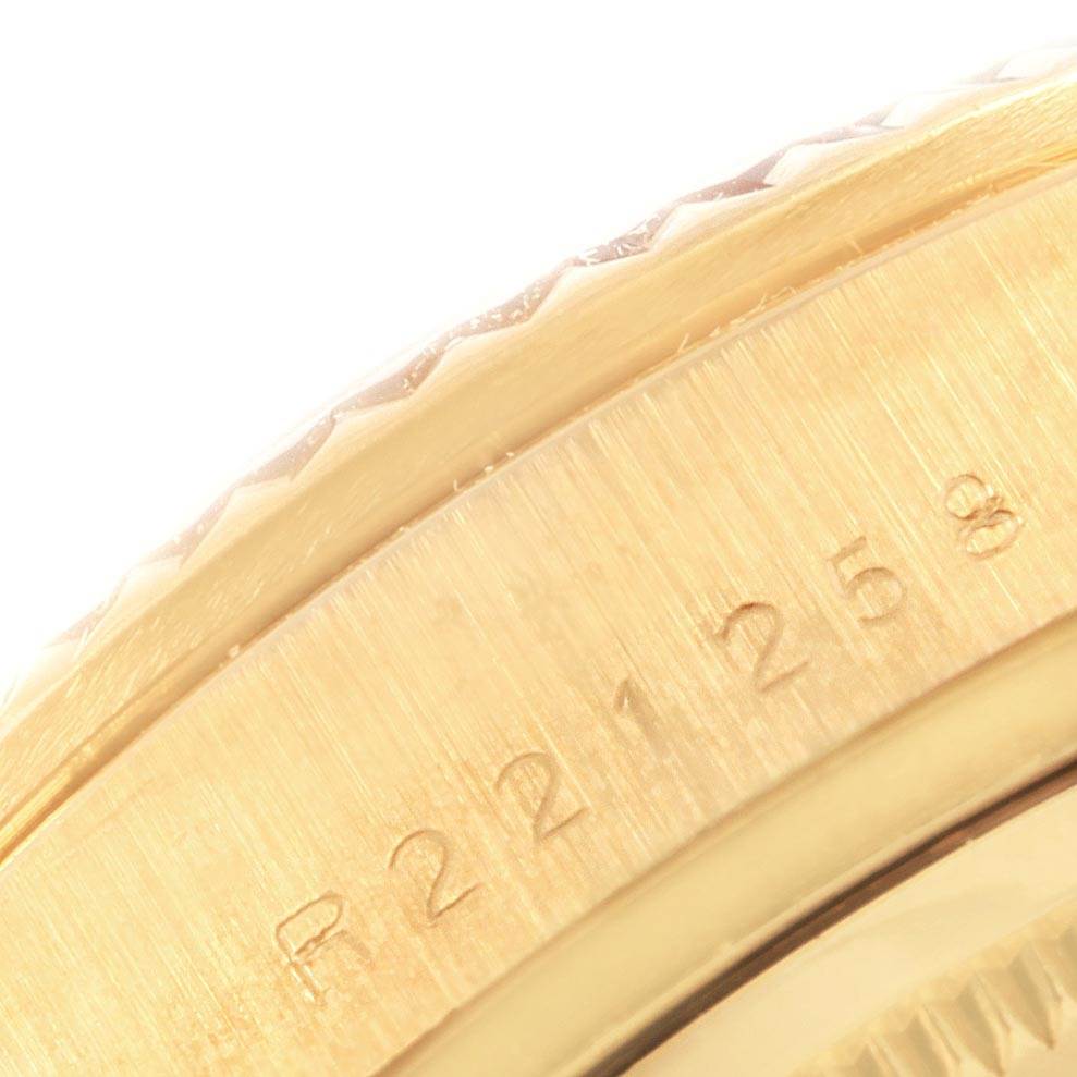 This close-up image of the President model by Rolex shows a portion of the bezel and engraved serial number.