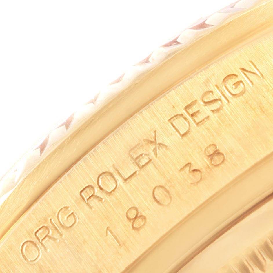 This image shows a close-up of the engraving on the bezel and case of a Rolex President 18038 Men
s Yellow Gold Blue Dial 18038 Men
s Yellow Gold Blue Dial model watch.