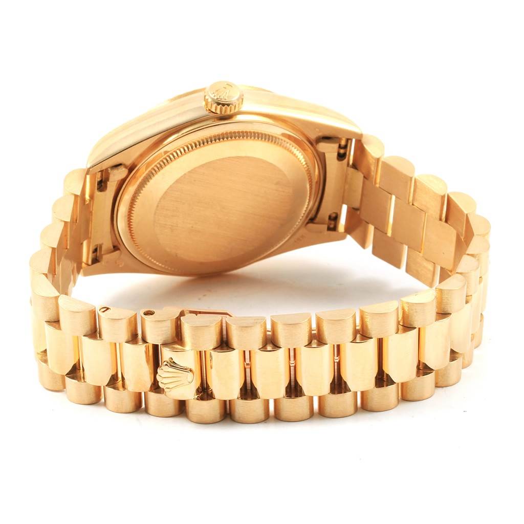 The image shows the back side and bracelet of a Rolex President 18038 Men
s Yellow Gold Blue Dial 18038 Men
s Yellow Gold Blue Dial model watch, highlighting the caseback and clasp.