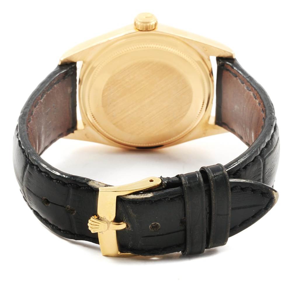 The image shows the back case and strap of the Rolex President 1803 Men
s Yellow Gold Black Dial 1803 Men
s Yellow Gold Black Dial model watch.