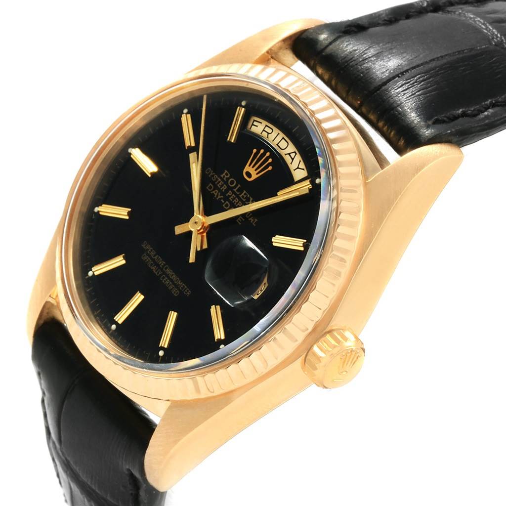 This image shows a Rolex President 1803 Men
s Yellow Gold Black Dial 1803 Men
s Yellow Gold Black Dial model watch from a slightly tilted angle, highlighting the dial, bezel, crown, and leather strap.