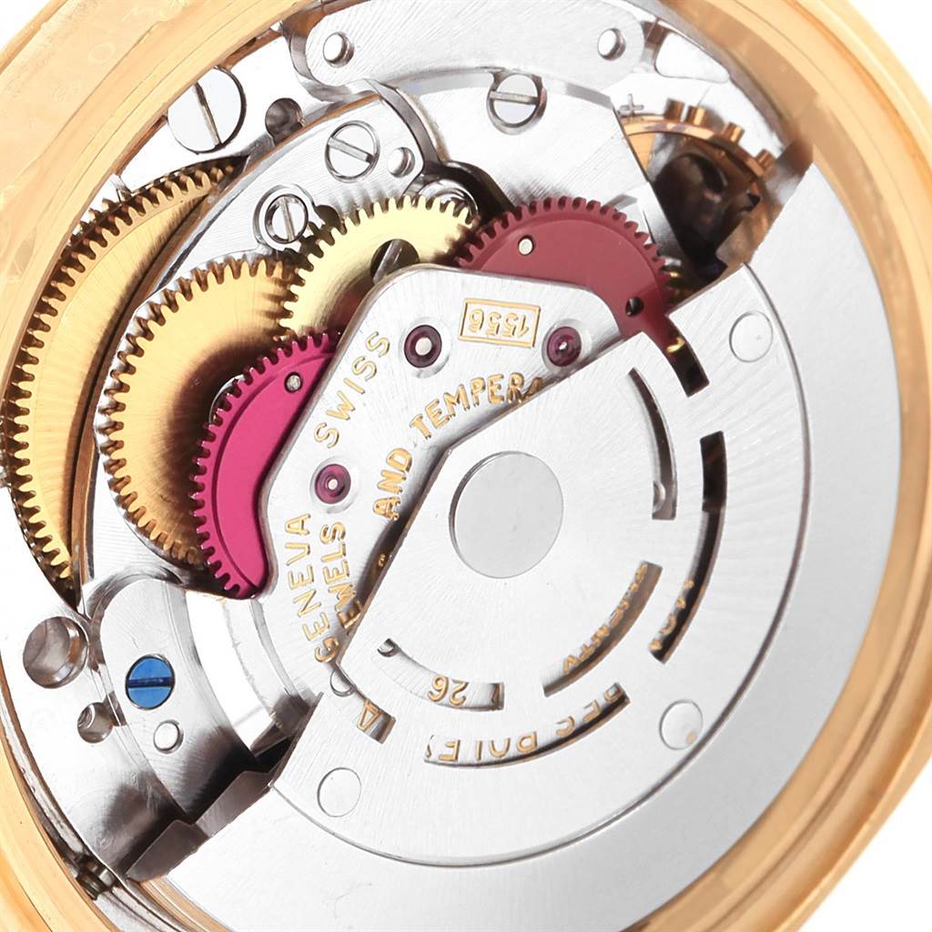 The image shows a close-up view of the internal mechanical movement of a Rolex President 1803 Men
s Yellow Gold Black Dial 1803 Men
s Yellow Gold Black Dial model, highlighting its gears and intricate parts.