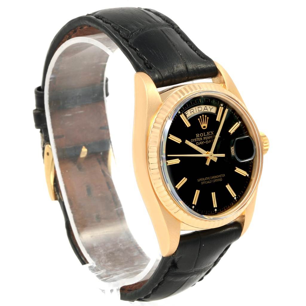 The Rolex President 1803 Men
s Yellow Gold Black Dial 1803 Men
s Yellow Gold Black Dial model watch is illustrated from a front angled view, showcasing its black dial, gold case, and black leather strap.
