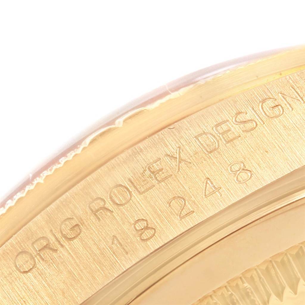 This is a close-up angle focusing on the engraved branding and serial number on the case of the Rolex President 20604 Men
s Yellow Gold Champagne Dial 20604 Men
s Yellow Gold Champagne Dial model watch.