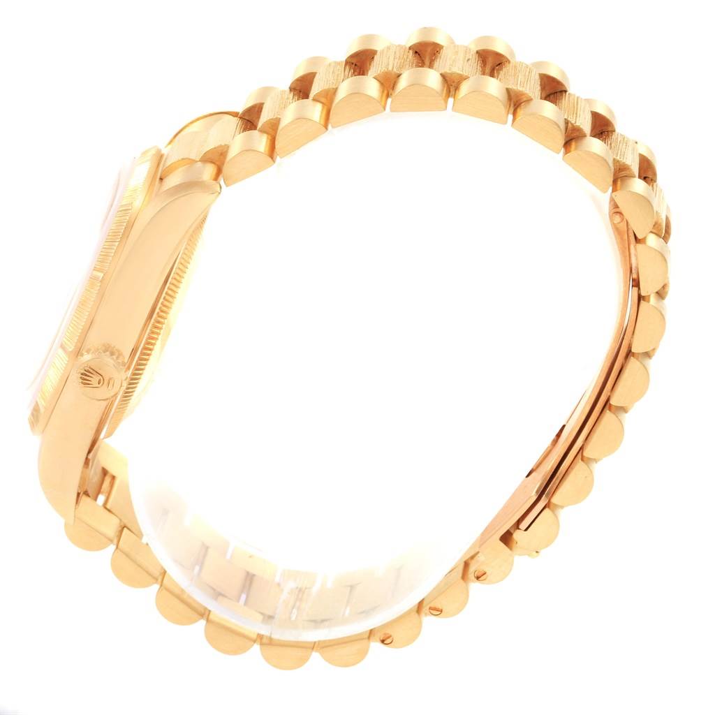 This is a side view of a Rolex President 20604 Men
s Yellow Gold Champagne Dial 20604 Men
s Yellow Gold Champagne Dial watch, showing its gold case and bracelet.