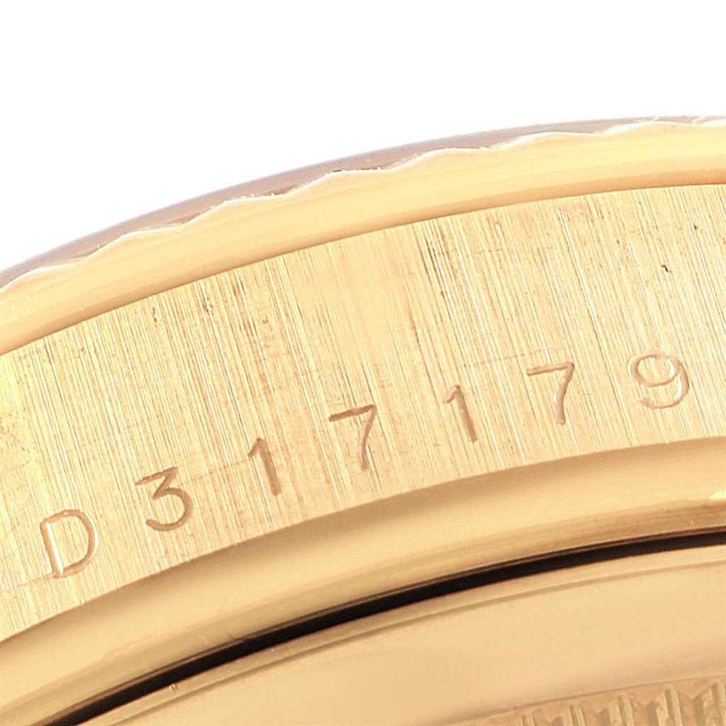 The image shows a close-up view of the bezel and engraved serial number on a Rolex President 118238 Men's Yellow Gold Black Dial 118238 Men's Yellow Gold Black Dial model watch.