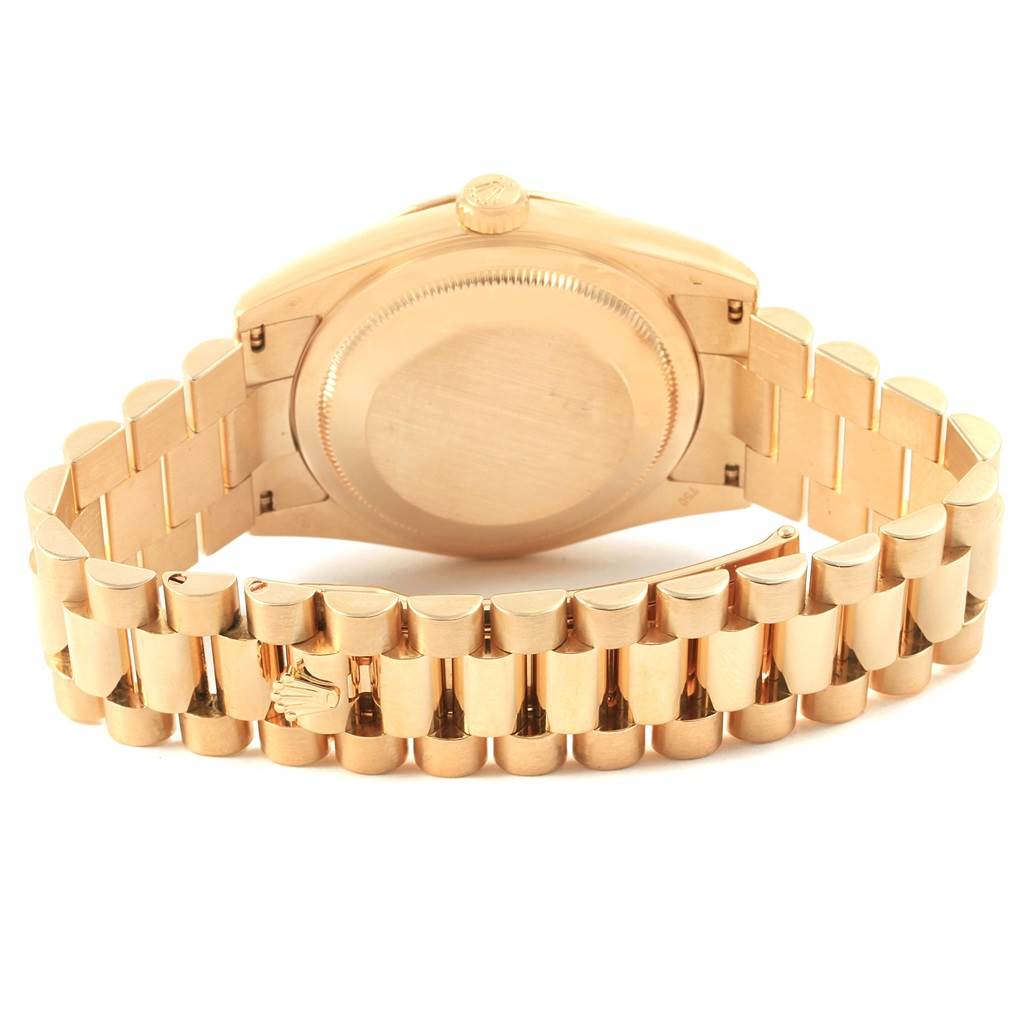 This image shows the back and bracelet of a Rolex President 118238 Men's Yellow Gold Black Dial 118238 Men's Yellow Gold Black Dial model watch from a slightly low angle.