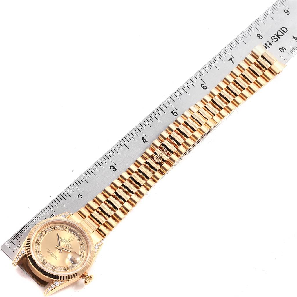 The image shows a top-down view of a Rolex President 118338 Men
s Yellow Gold Champagne Dial 118338 Men
s Yellow Gold Champagne Dial model watch with the face and band, next to a ruler for scale.