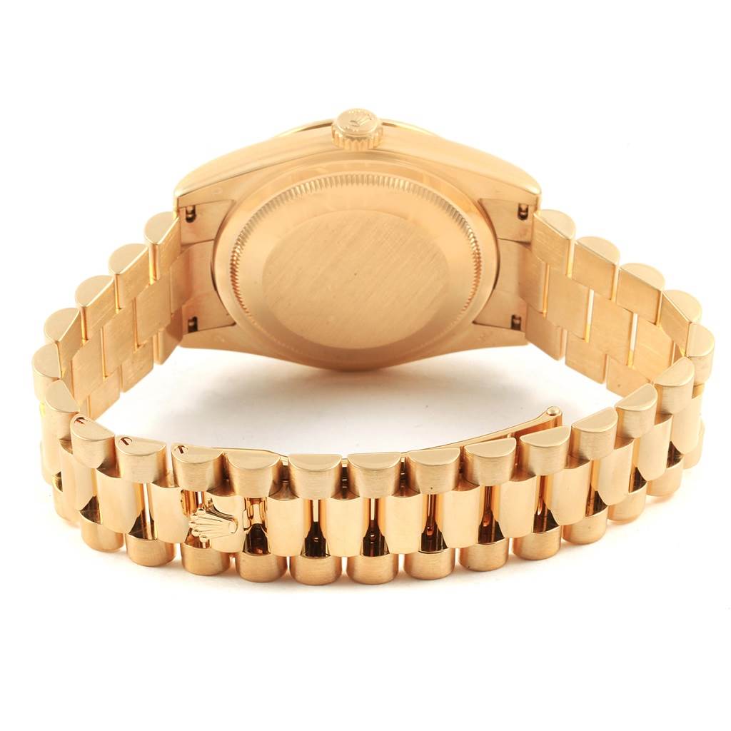 The image shows the back side and bracelet of a Rolex President 118338 Men
s Yellow Gold Champagne Dial 118338 Men
s Yellow Gold Champagne Dial model watch, highlighting the case back and clasp.
