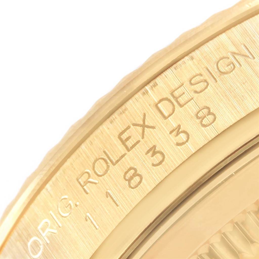 Close-up of the bezel and part of the case of a Rolex President 118338 Men
s Yellow Gold Champagne Dial 118338 Men
s Yellow Gold Champagne Dial model watch with visible engravings.