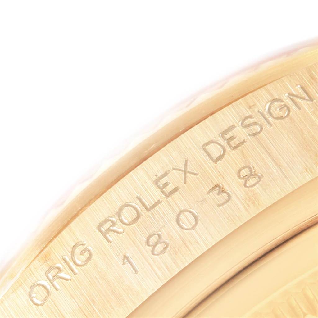 The image shows a close-up of the engraved bezel of the Rolex President 18038 Men
s Yellow Gold Mother of Pearl Dial 18038 Men
s Yellow Gold Mother of Pearl Dial model, showcasing its serial number and "Orig Rolex Design" text.