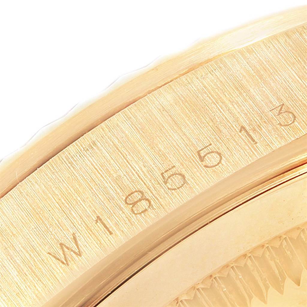 This close-up of the Rolex President 18238 Men
s Yellow Gold White Dial 18238 Men
s Yellow Gold White Dial watch shows part of the casing with a partial serial number.