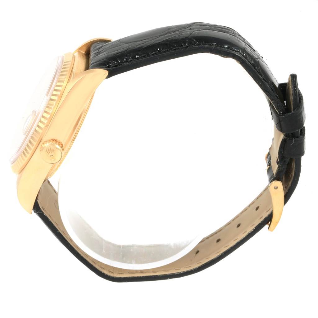 This image shows a side view of the Rolex President 18038 Men
s Yellow Gold Champagne Dial 18038 Men
s Yellow Gold Champagne Dial model watch, highlighting its gold case and black leather strap.