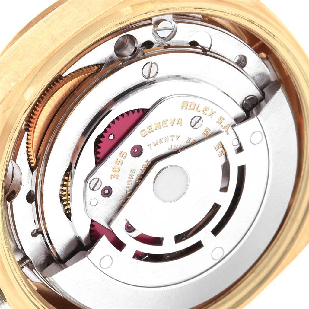 The image shows an up-close view of the movement inside the Rolex President 18038 Men
s Yellow Gold Champagne Dial 18038 Men
s Yellow Gold Champagne Dial model watch with visible gears and inscriptions.