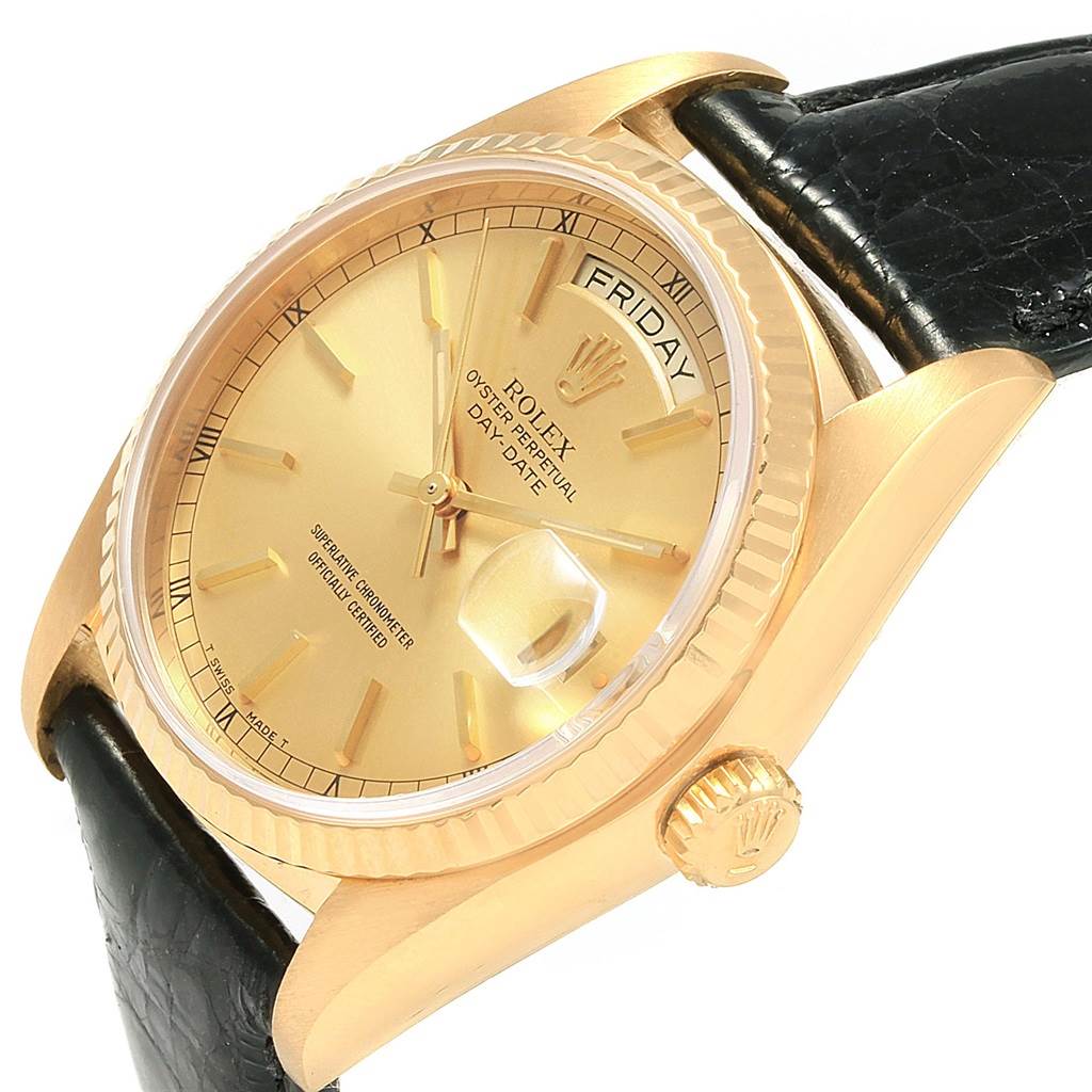 The image shows a close-up angle of the President model Rolex watch, highlighting its gold face, bezel, crown, and part of the black strap.