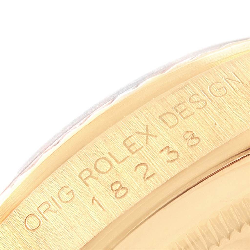 This close-up image shows a part of the bezel and case of the Rolex President 18238 Men
s Yellow Gold Champagne Dial 18238 Men
s Yellow Gold Champagne Dial model with engraved markings.