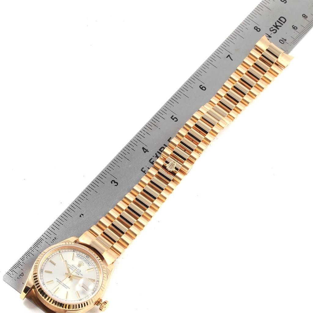 This image shows the Rolex President 118238 Men's Yellow Gold Silver Dial 118238 Men's Yellow Gold Silver Dial model watch laid flat with a ruler measuring its gold bracelet.