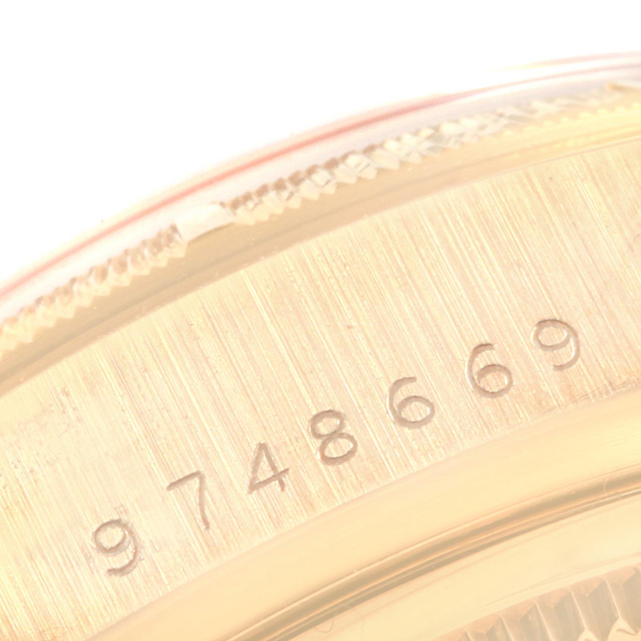 This image shows a close-up angle of the serial number on the case side of a Rolex President 18078 Men's Yellow Gold Champagne Dial 18078 Men's Yellow Gold Champagne Dial model watch.