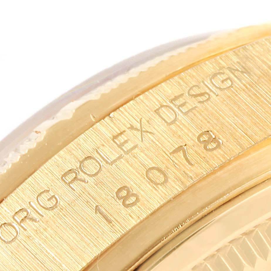 This image shows a close-up of the side of the gold case on the Rolex President 18078 Men's Yellow Gold White Dial 18078 Men's Yellow Gold White Dial model, featuring engraved text and the model number.