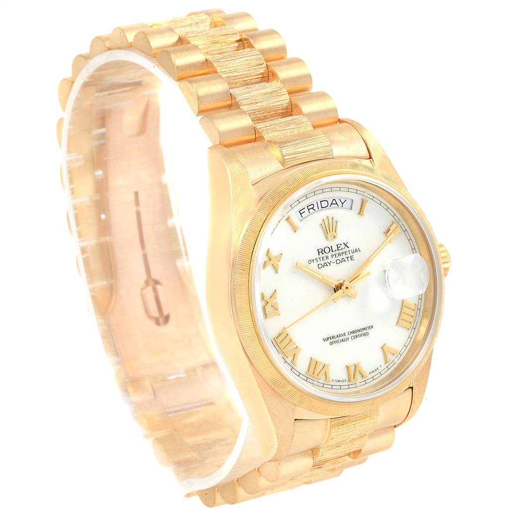 This President model by Rolex is shown at a three-quarter angle, displaying the face, bezel, and part of the bracelet.