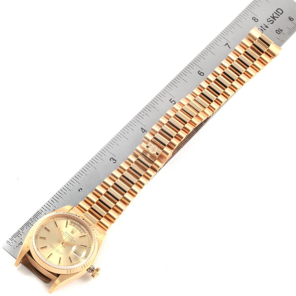 The image shows a Rolex President 18038 Men
s Yellow Gold Champagne Dial 18038 Men
s Yellow Gold Champagne Dial model watch laid out beside a ruler, displaying the watch face and full bracelet.