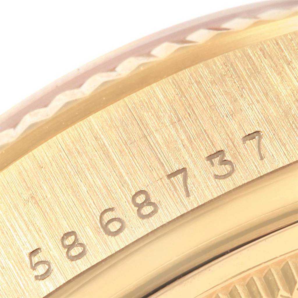 The image shows a close-up of the serial number engraving on the bezel of a Rolex President 18038 Men
s Yellow Gold Champagne Dial 18038 Men
s Yellow Gold Champagne Dial model watch.