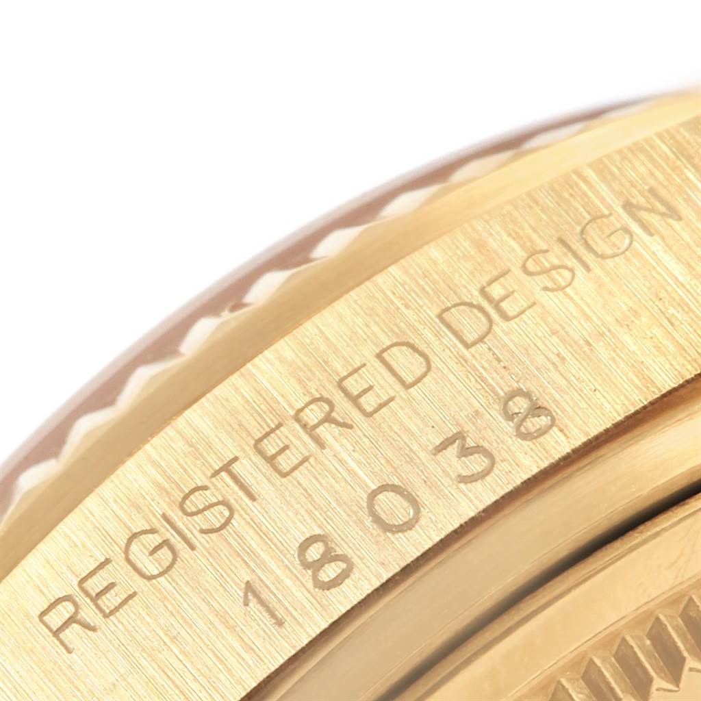 This image shows a close-up of the side of a Rolex President 18038 Men
s Yellow Gold Champagne Dial 18038 Men
s Yellow Gold Champagne Dial model watch, highlighting the engraved text and part of the bezel.