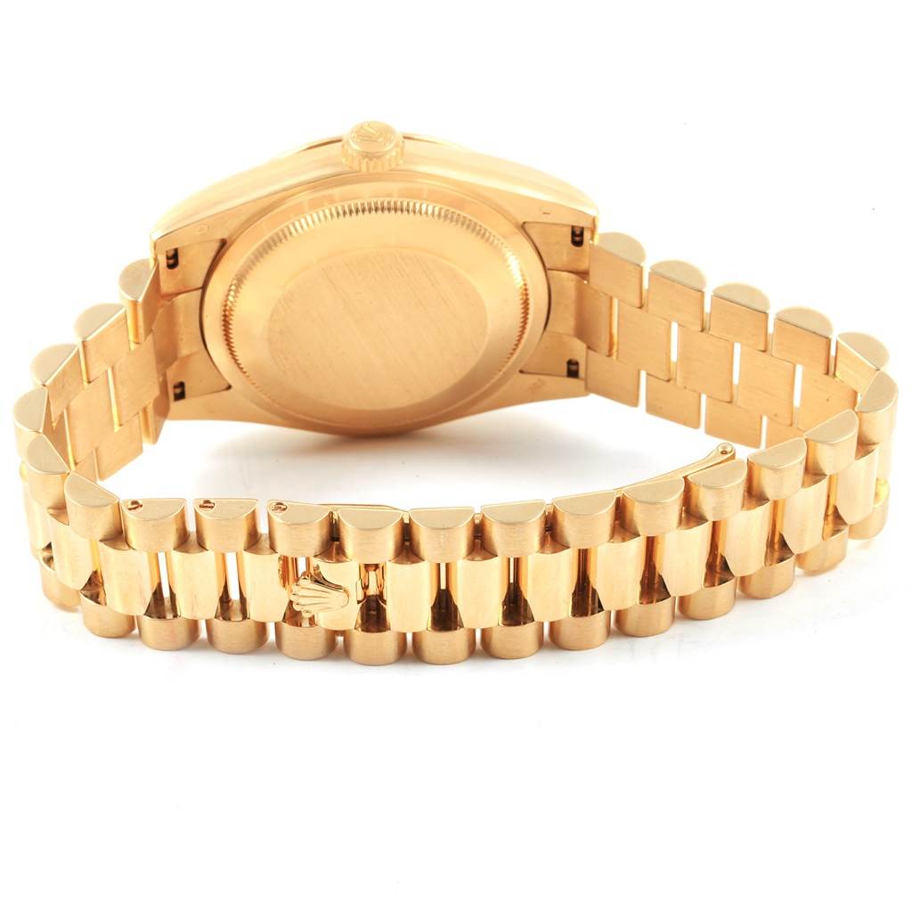 The image shows the back case and bracelet of a Rolex President 118238 Men's Yellow Gold White Dial 118238 Men's Yellow Gold White Dial model watch at an upward angle.