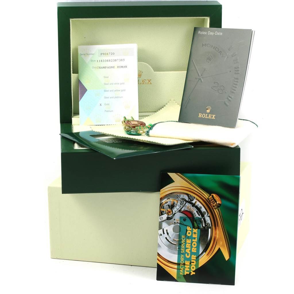 The image shows accessories and packaging of the Rolex President 118338 Men
s Yellow Gold Champagne Dial 118338 Men
s Yellow Gold Champagne Dial model, including manuals, cards, and a box.