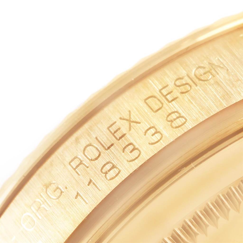 This image shows a close-up of the bezel and part of the case of a Rolex President 118338 Men
s Yellow Gold Champagne Dial 118338 Men
s Yellow Gold Champagne Dial model watch.
