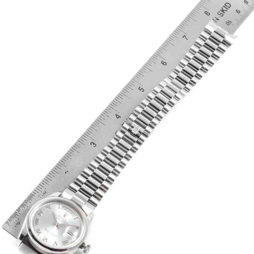 The image shows the Rolex President 118206 Men's Platinum Blue Dial 118206 Men's Platinum Blue Dial model watch laid flat next to a ruler, highlighting its full strap length.