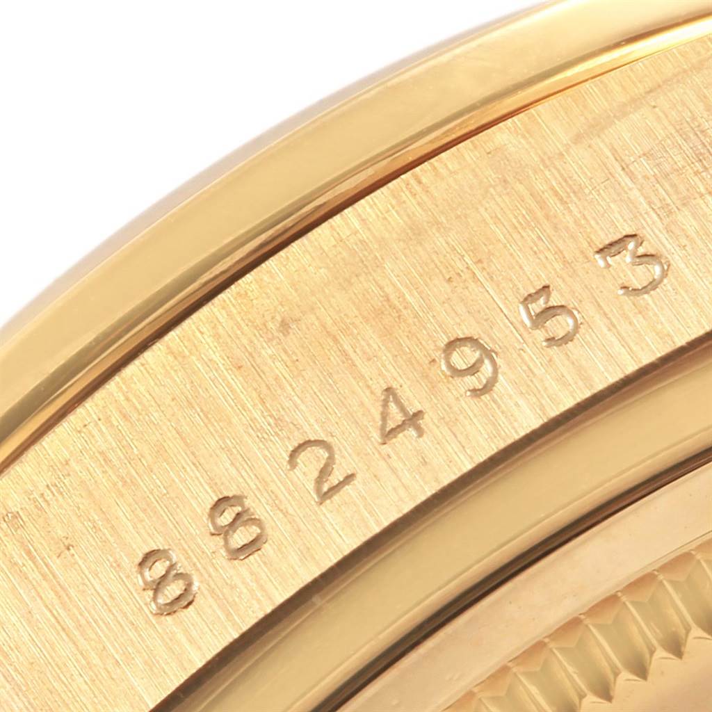 This Rolex President 18048 Men
s Yellow Gold Champagne Dial 18048 Men
s Yellow Gold Champagne Dial model is shown at an angled close-up, focusing on its serial number engraving.