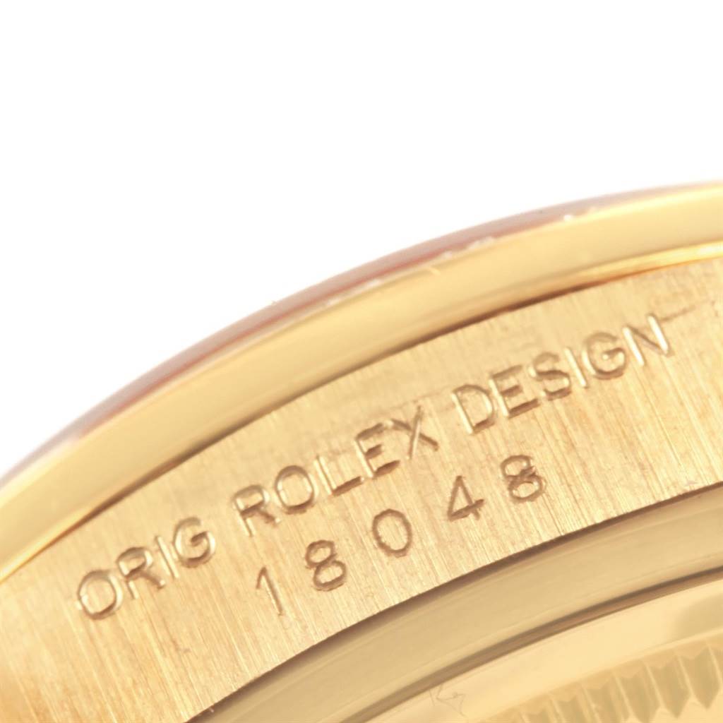 This image shows a close-up of the engraved bezel on a Rolex President 18048 Men
s Yellow Gold Champagne Dial 18048 Men
s Yellow Gold Champagne Dial model watch, displaying the design number.