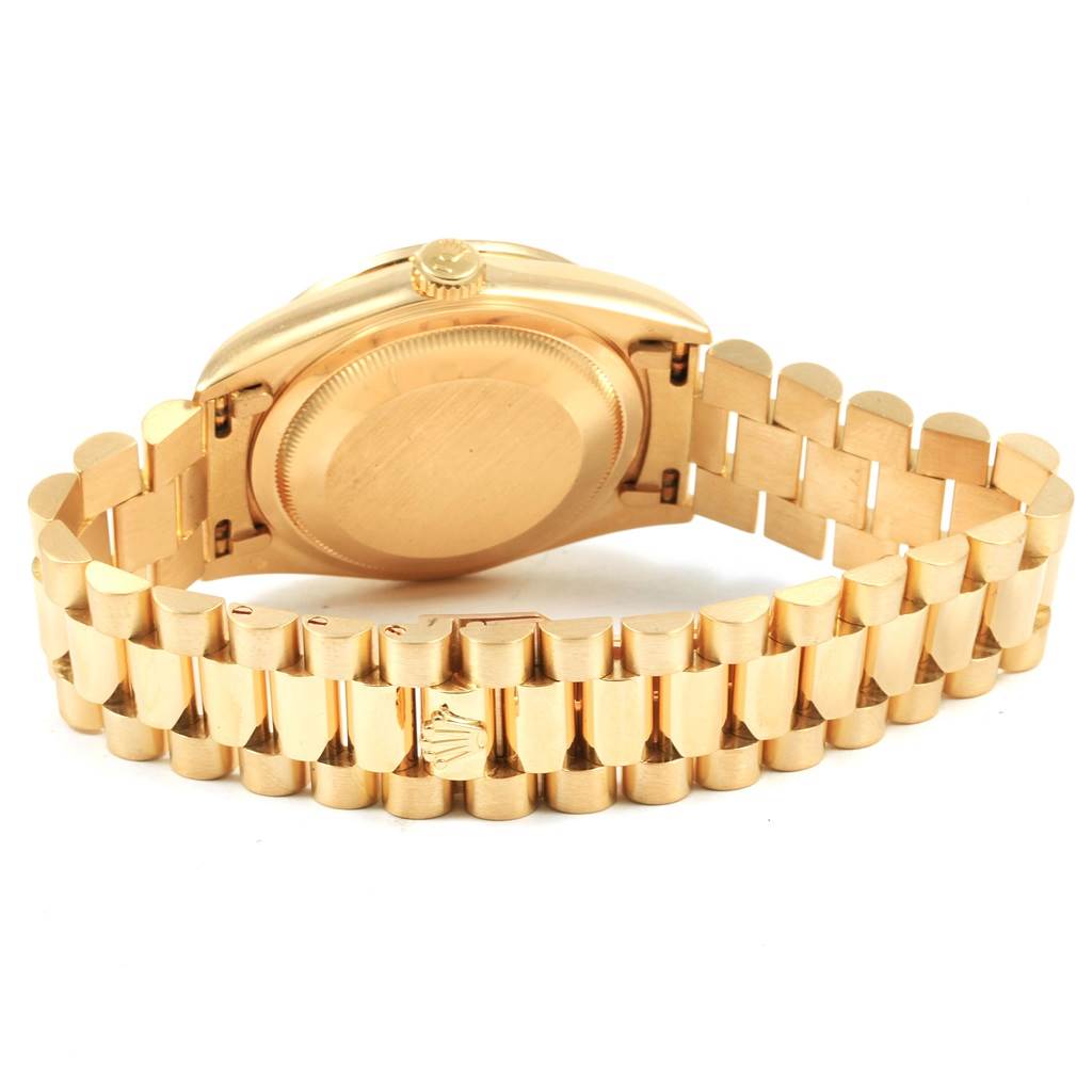 The image shows the back and bracelet of the Rolex President 18388 Men
s Yellow Gold Champagne Dial 18388 Men
s Yellow Gold Champagne Dial model watch, highlighting its clasp and case back.