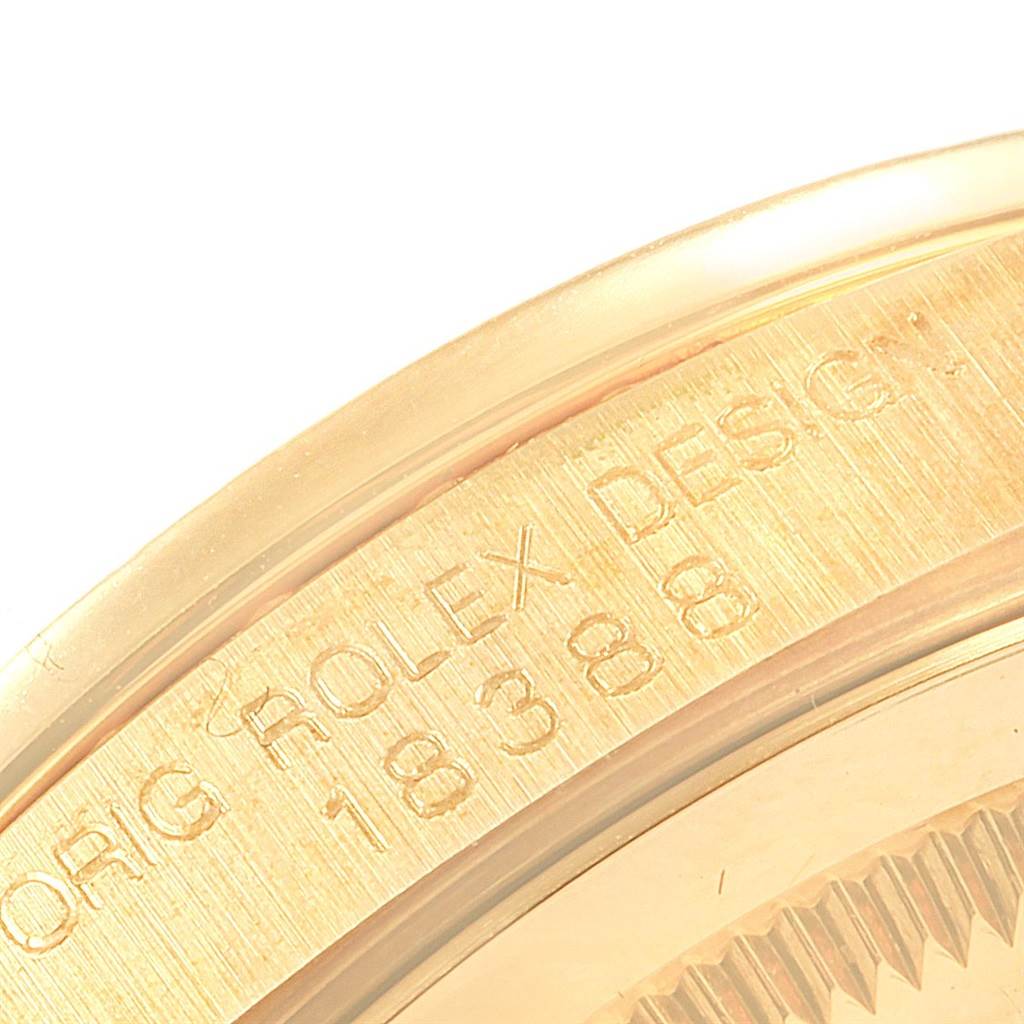 This image shows a close-up of the engraved bezel and case of a Rolex President 18388 Men
s Yellow Gold Champagne Dial 18388 Men
s Yellow Gold Champagne Dial model watch.