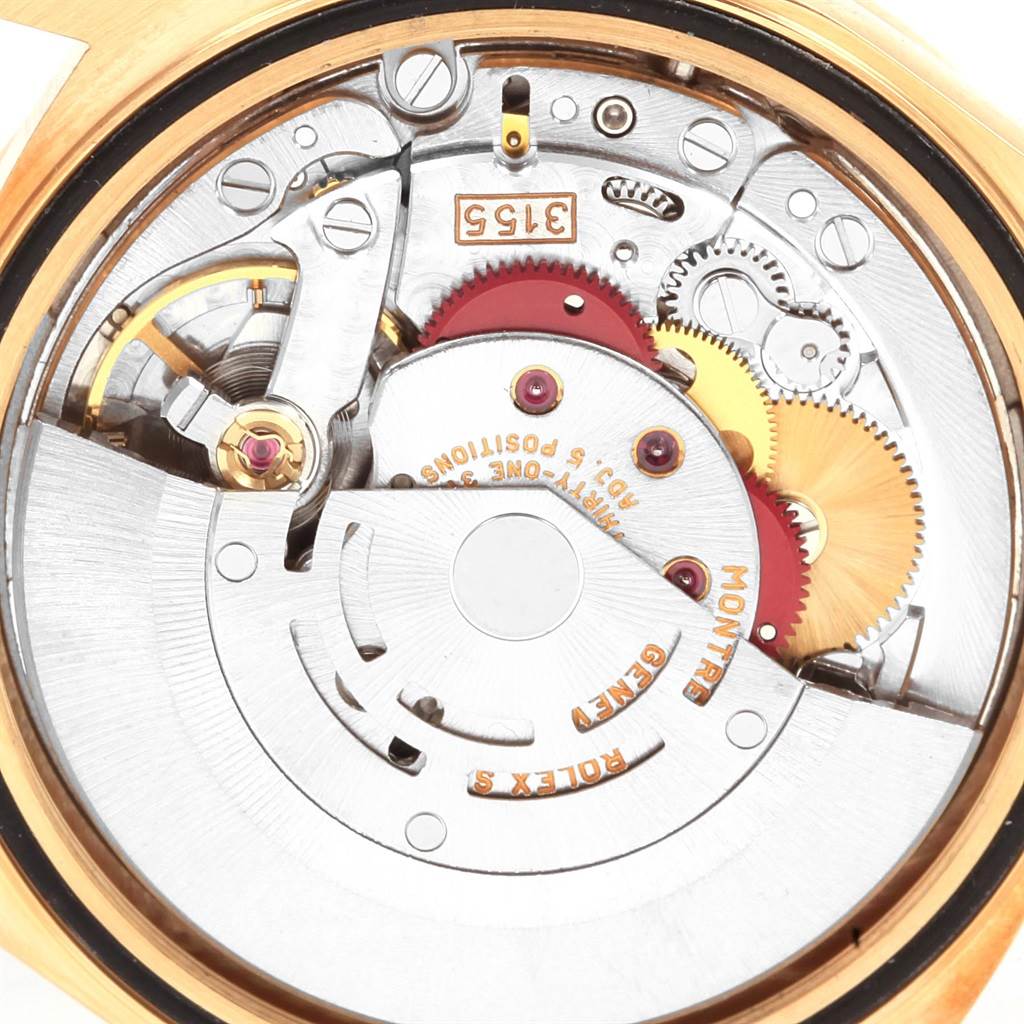 The image shows a close-up of the internal mechanical movement of a Rolex President 18388 Men
s Yellow Gold Champagne Dial 18388 Men
s Yellow Gold Champagne Dial watch, highlighting gears and the rotor.
