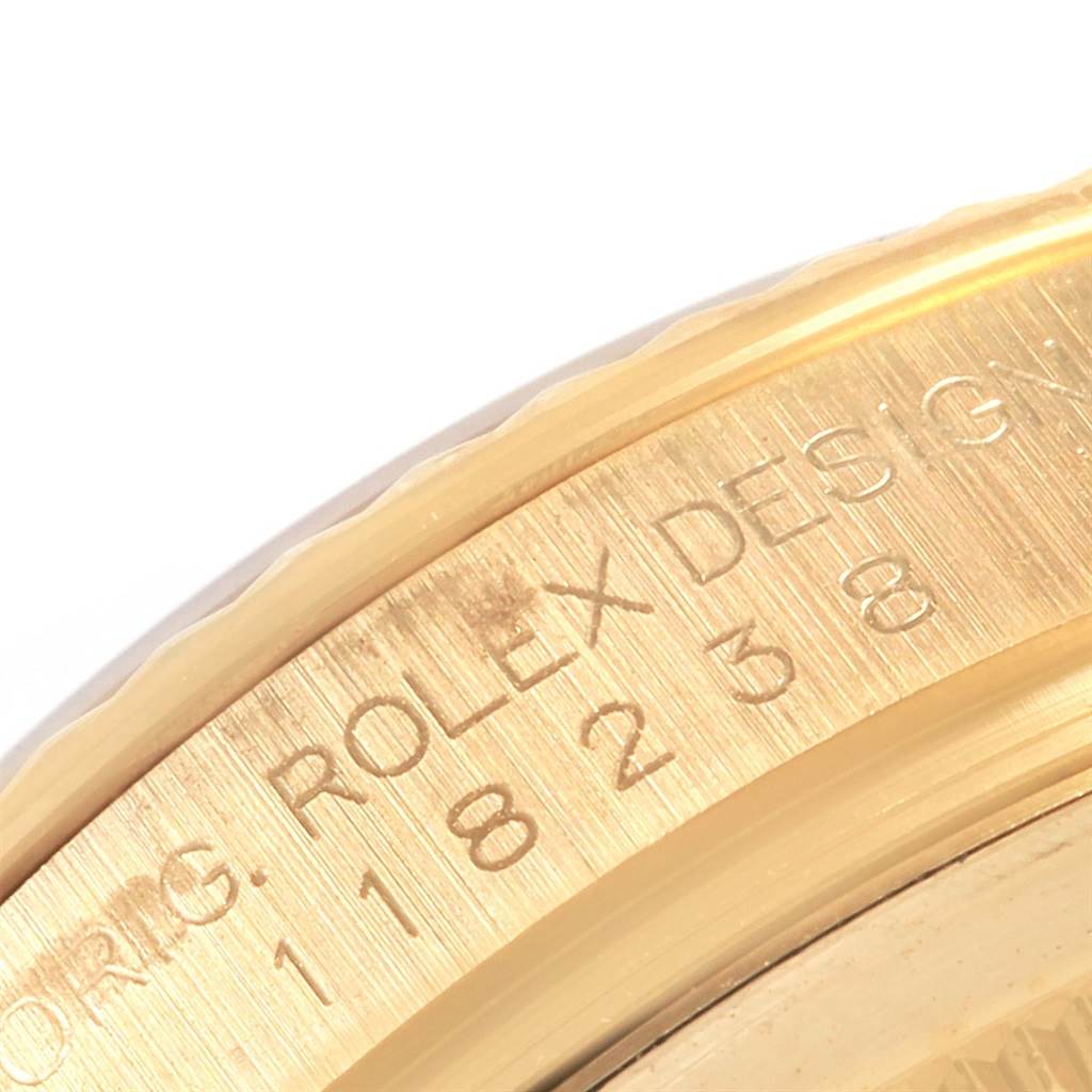 This close-up shows the side engraving and fluted bezel of a Rolex President 118238 Men
s Yellow Gold Champagne Dial 118238 Men
s Yellow Gold Champagne Dial model watch.