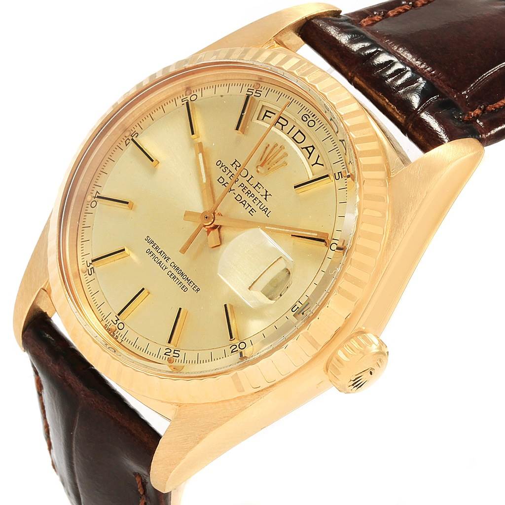 This image shows a close-up angled view of the Rolex President 1804 Men
s Yellow Gold Champagne Dial 1804 Men
s Yellow Gold Champagne Dial watch face, bezel, crown, and brown leather strap.