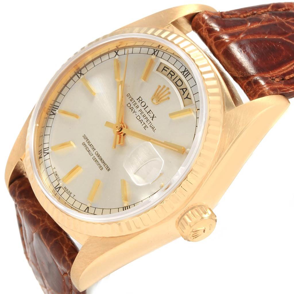The Rolex President 18038 Men
s Yellow Gold Champagne Dial 18038 Men
s Yellow Gold Champagne Dial model watch is shown at an angled view, displaying the dial, day/date window, crown, and part of the leather strap.