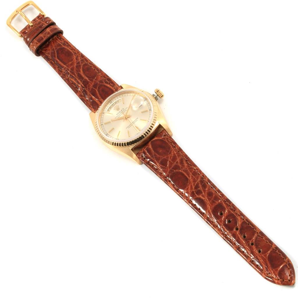 The Rolex President 18038 Men
s Yellow Gold Champagne Dial 18038 Men
s Yellow Gold Champagne Dial watch model is shown at an angled top view displaying the dial, bezel, crown, and brown leather strap with buckle.