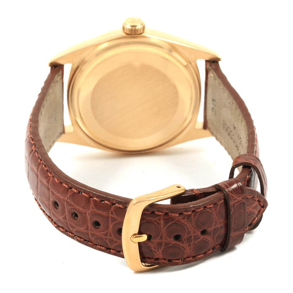 This image shows the back of a Rolex President 1803 Men's Yellow Gold Champagne Dial 1803 Men's Yellow Gold Champagne Dial model watch, including the case back and the leather strap with a buckle.