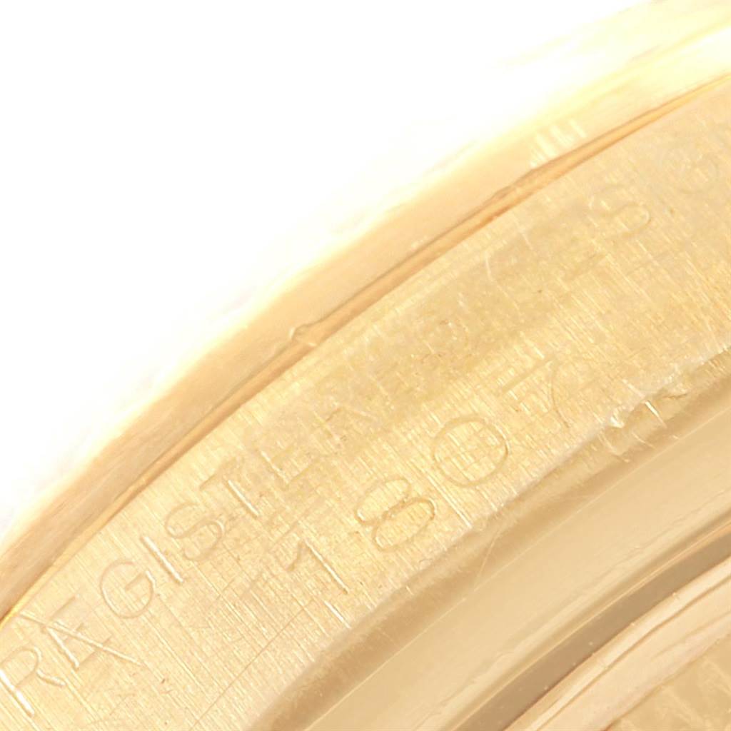 This is a close-up image of the engraved edge of the President model by Rolex, showing part of the bezel.
